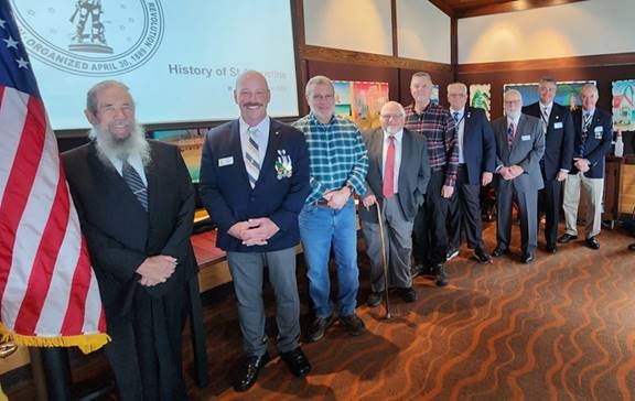A group of men standing in a row

AI-generated content may be incorrect.