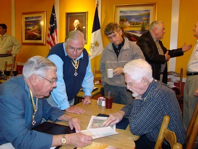 Members converse prior to a monthly meeting